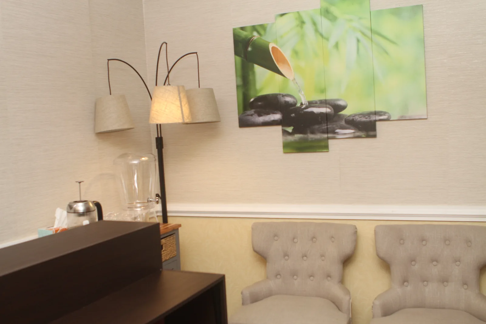 Waiting lounge with upholstered armchairs and water service