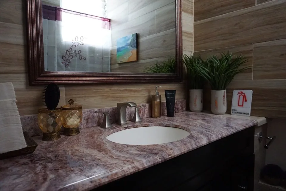 Guest vanity with mirror, towels and amenities